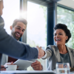 Woman shaking a man's hand in a meeting